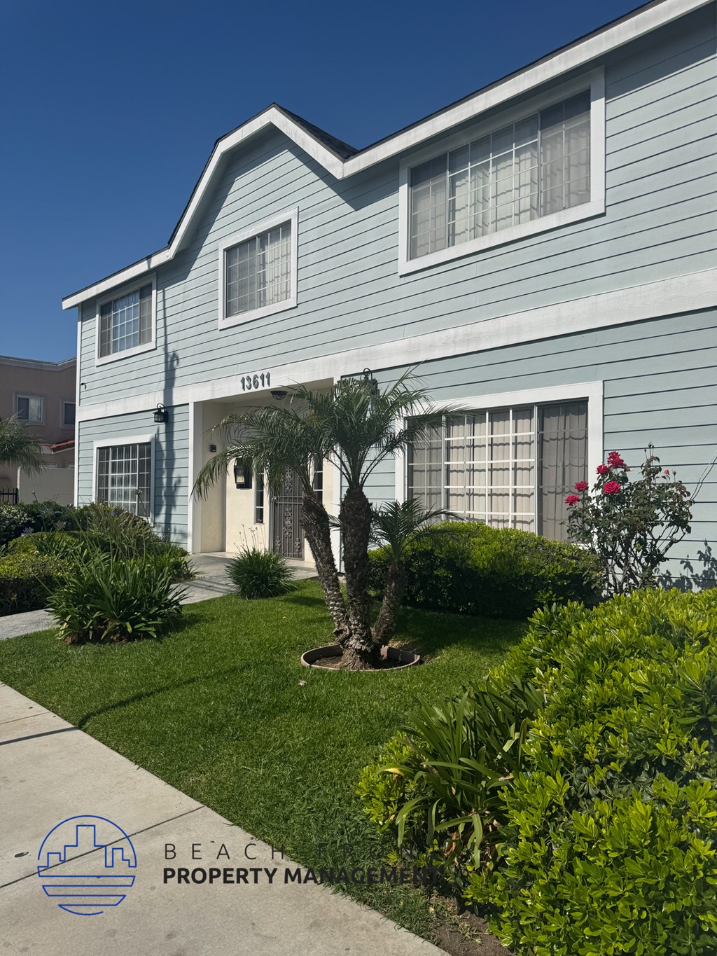 A blue house with the number 13611 on it.