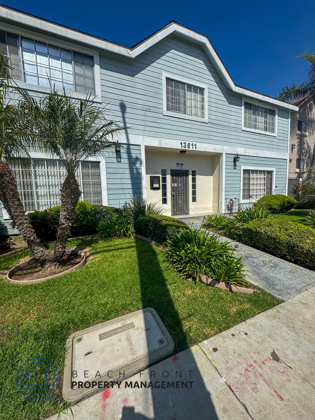 A blue house with the number 13611 on it.