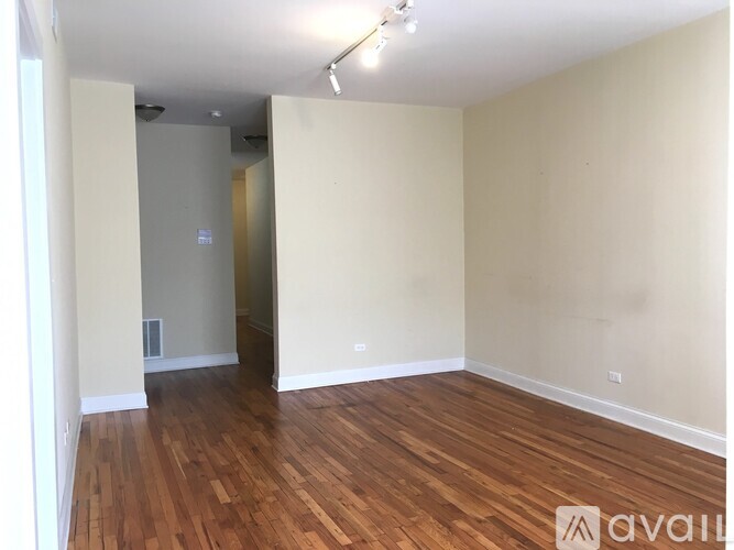 A room with wooden floors and white walls.