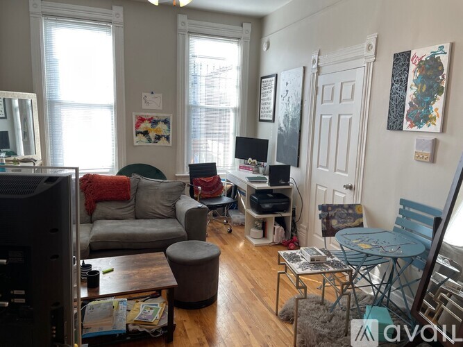 A living room with a grey couch, a black television, and a coffee table.