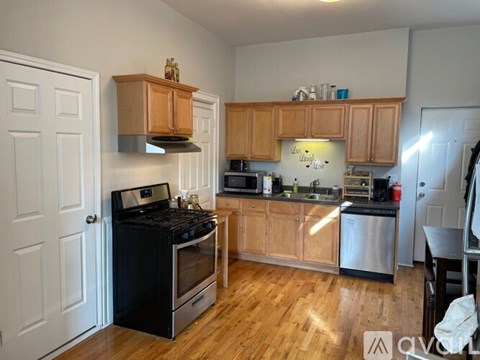 A kitchen with wooden cabinets and a black stove top oven.