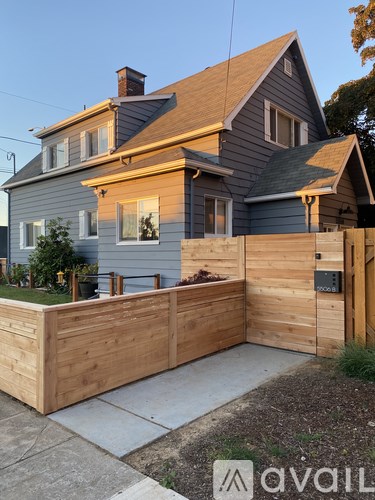 A house with a grey exterior and a wooden fence.