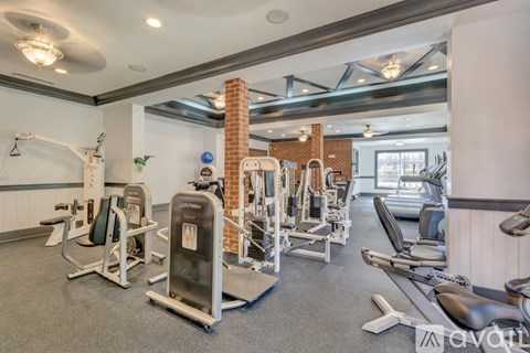 A well-equipped gym with a variety of machines and weights.