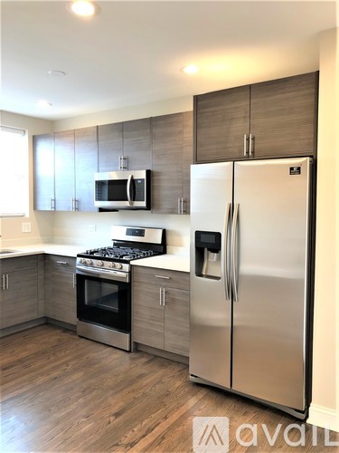 A kitchen with a stainless steel refrigerator and oven.