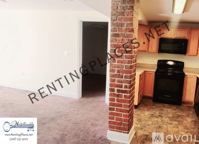 A room with a ceiling fan and a sign that says "McGillicuddy RENTAL PROPERTIES".