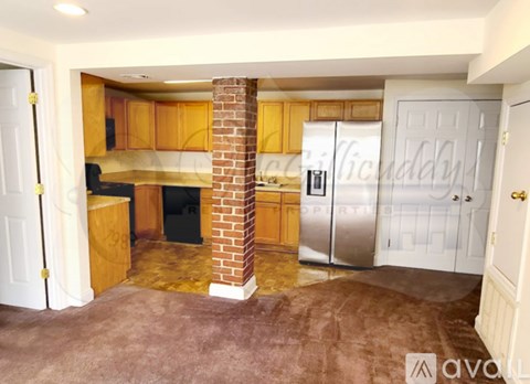 A kitchen with wooden cabinets and a brick chimney.