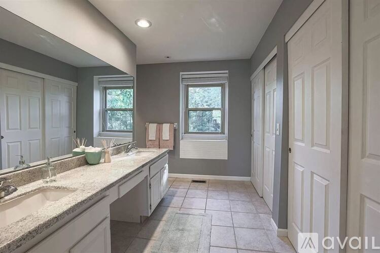 A bathroom with two sinks and a large mirror.