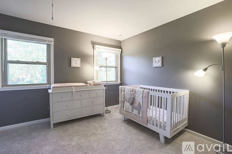 A baby room with a crib and a dresser.