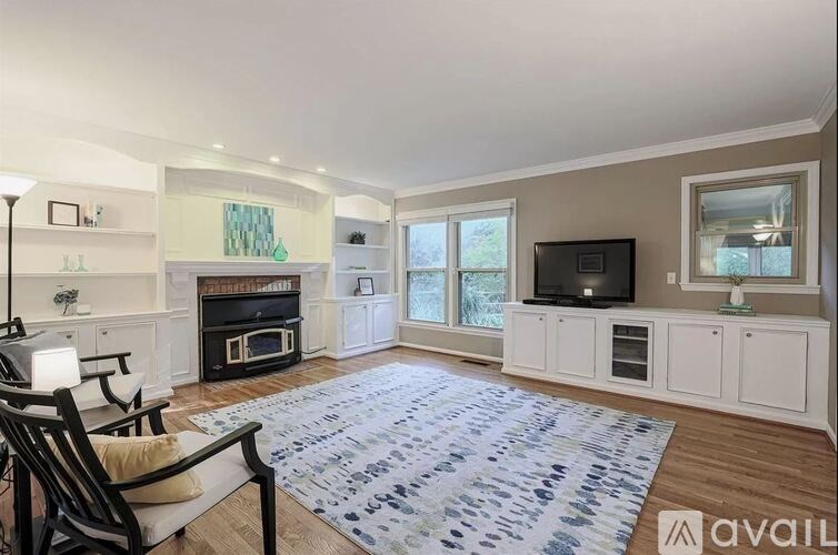 A living room with a fireplace and a television.