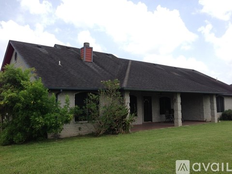 A house with a red chimney and a grey roof.