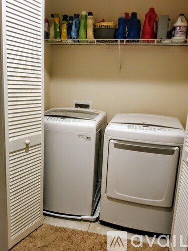 A small laundry room with a washer and dryer.