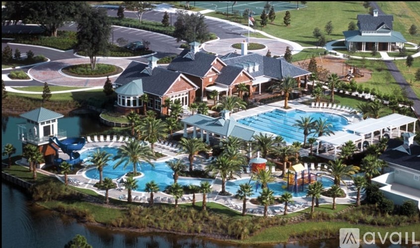 A large resort with a pool and palm trees.