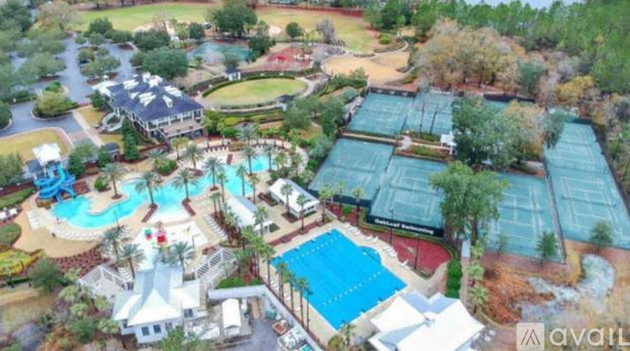 An aerial view of a resort with a pool and a water slide.