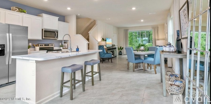 A kitchen with a bar area and a dining table.