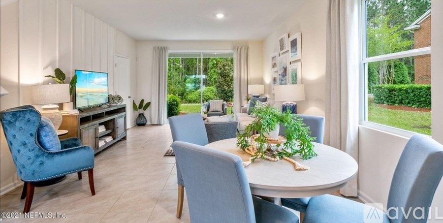 A living room with a blue chair and a white table.