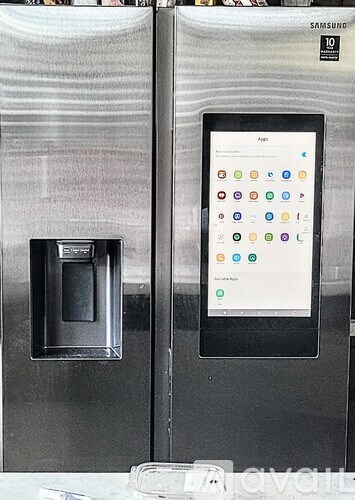 A Samsung tablet is displayed on a refrigerator.