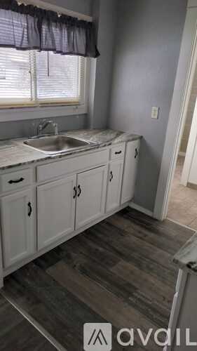 A kitchen with a sink and cabinets.