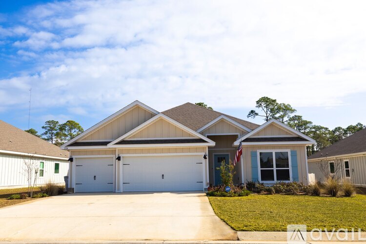 A house with a garage and a flag on the front.