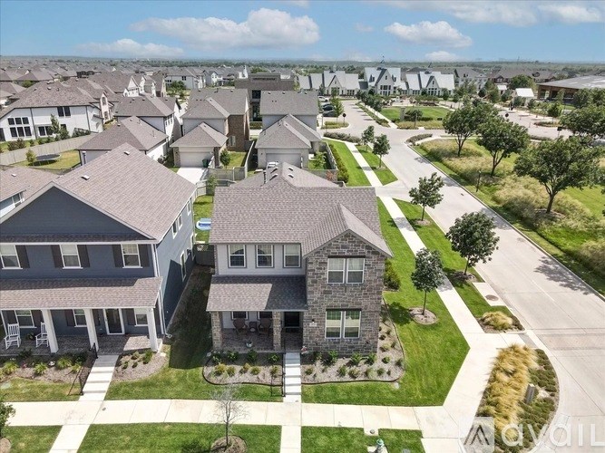 A suburban neighborhood with houses and well-maintained lawns.