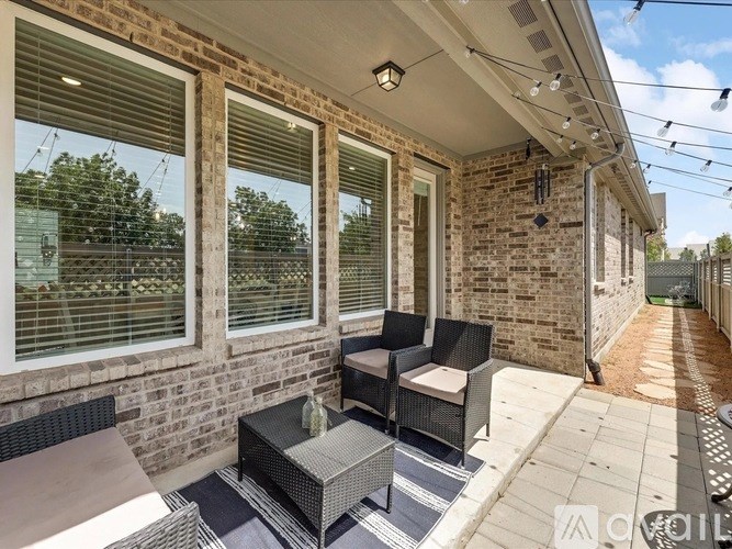 A patio with a table and chairs is shown.