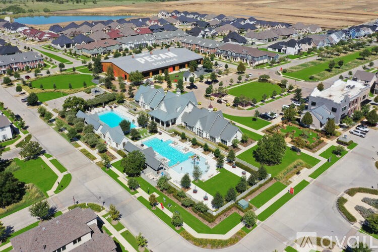 A bird's eye view of a residential area with houses and a swimming pool.