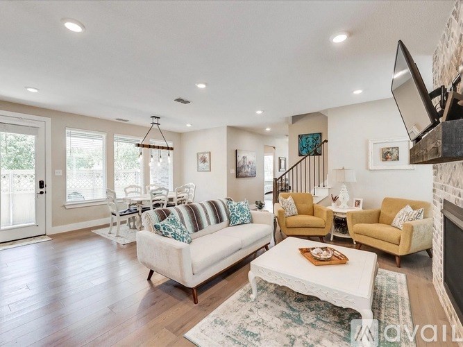A living room with a white couch and a rug.