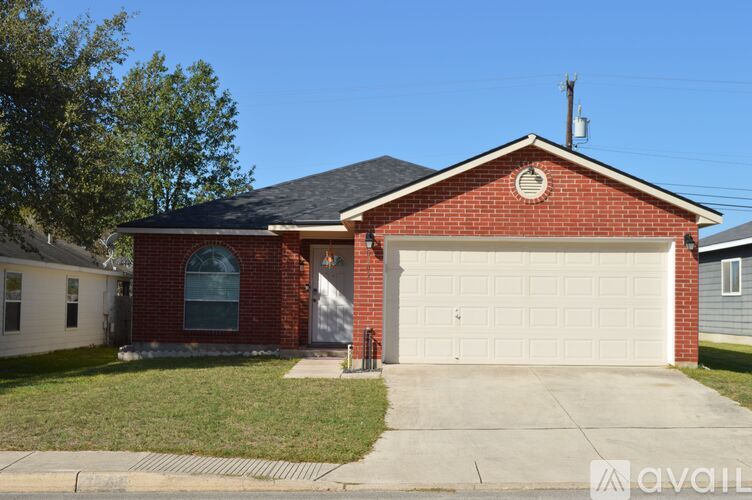 A red brick house with a white garage door.