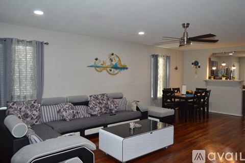 A living room with a grey couch and a coffee table.