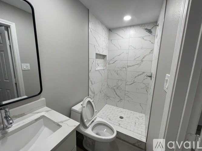 A bathroom with a toilet and sink.