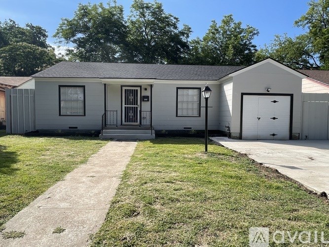 A small house with a front yard and a driveway.