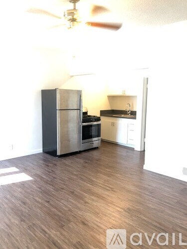 A kitchen with a stainless steel refrigerator and oven.