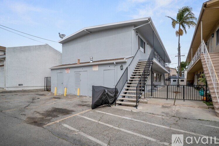 A grey building with a black tarp covering a staircase.