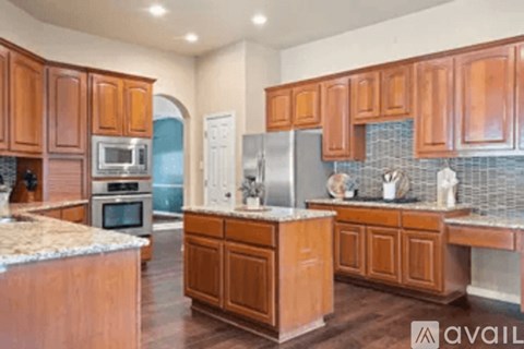 A kitchen with wooden cabinets and a granite counter top.