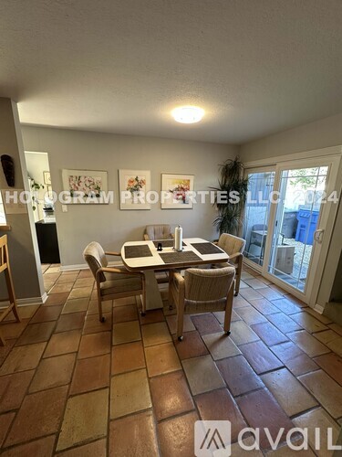 A dining room with a table set for four.
