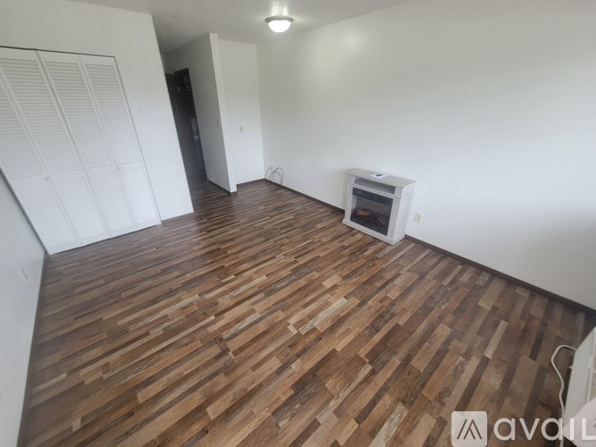 A room with wooden flooring and a window.