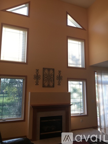 A living room with a fireplace and a window.
