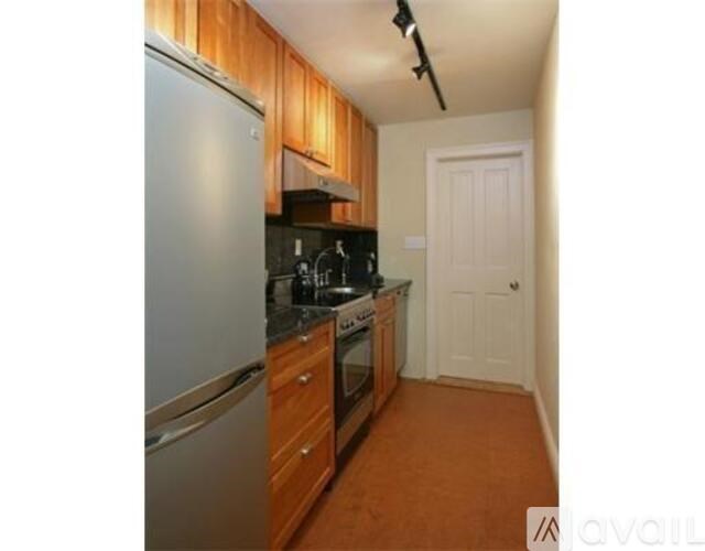 A kitchen with wooden cabinets and a white door.