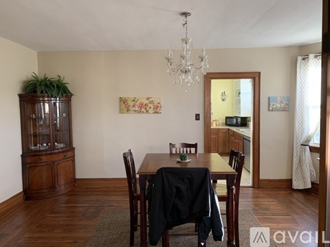A dining room with a wooden table and chairs.