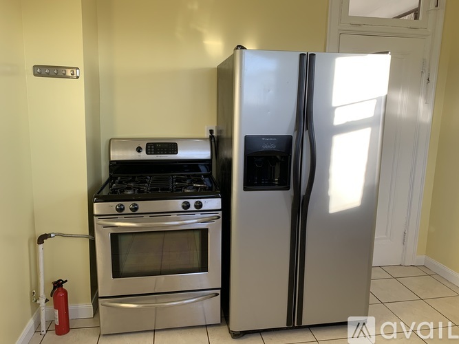 A kitchen with a stove, oven, and refrigerator.