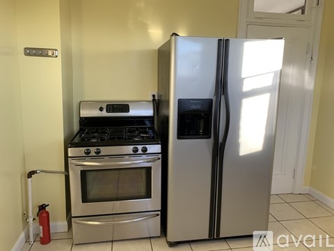 A kitchen with a stove, oven, and refrigerator.