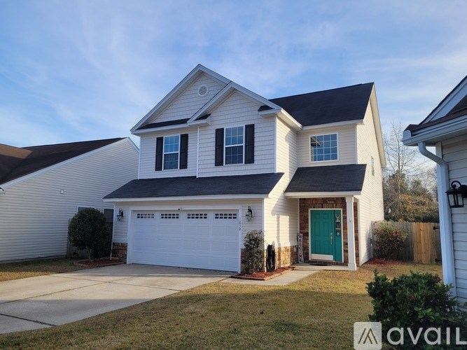 A two-story house with a white garage door is for sale.