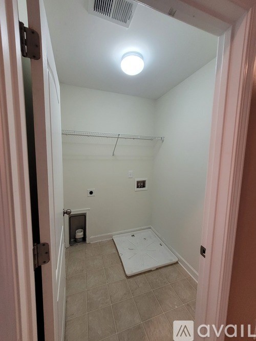 A bathroom with a toilet and a shower.