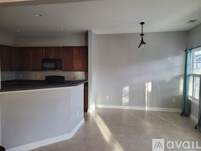 A kitchen with brown cabinets and a white countertop is available.