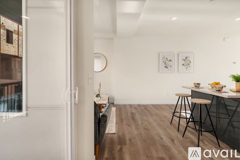 A modern kitchen with a dining table and chairs.