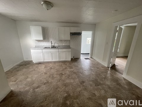 A kitchen area with a sink and cabinets.