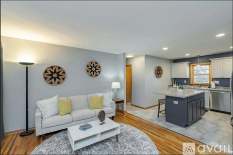A living room with a white couch and a coffee table.