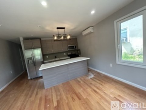 A kitchen with wooden floors and a window.