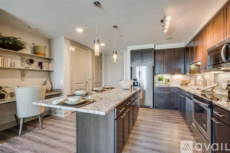 A modern kitchen with a center island and dark wood cabinets.