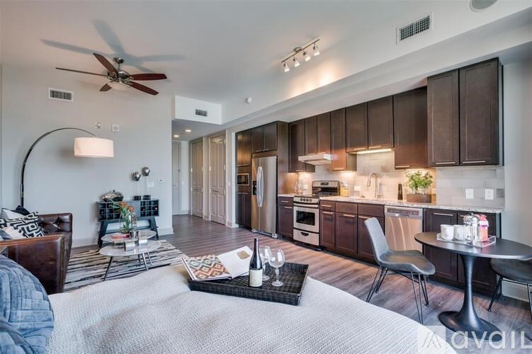 A living room with a couch, a coffee table, and a dining table with chairs.