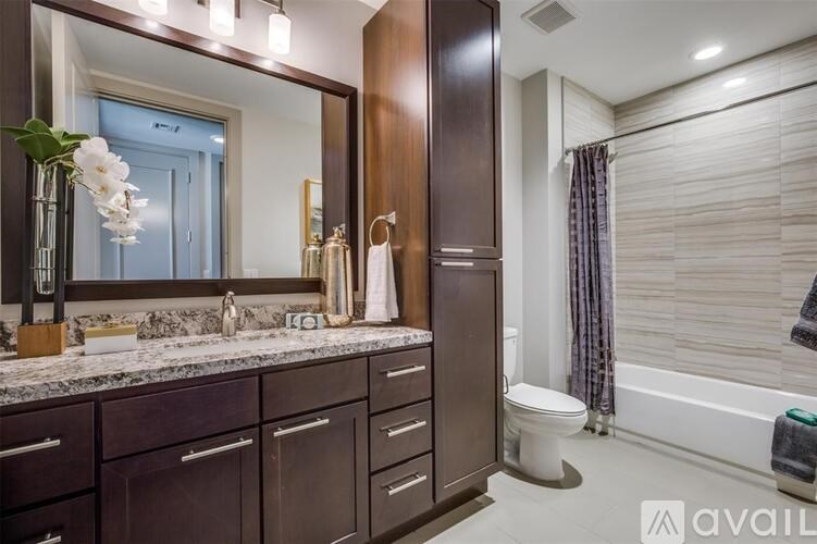 A bathroom with a sink, mirror, and toilet.